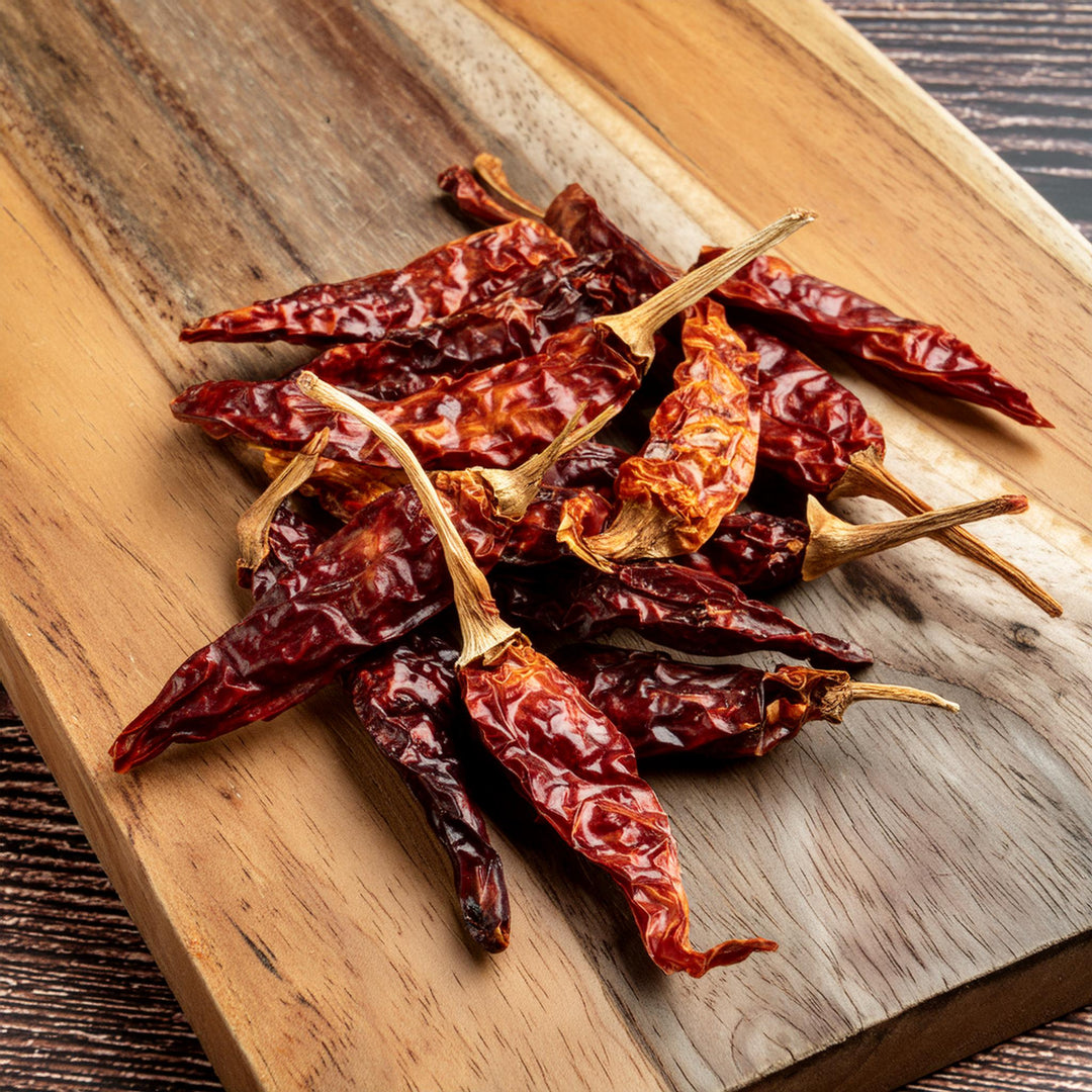 Whole Bird's Eye Chili peppers in a 50g package by AGT, vibrant red for authentic Thai cooking.