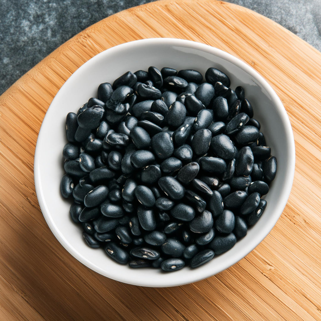 Dried organic black turtle beans in a clear bag by AGT, ideal for soups and burritos, available in multiple weights.