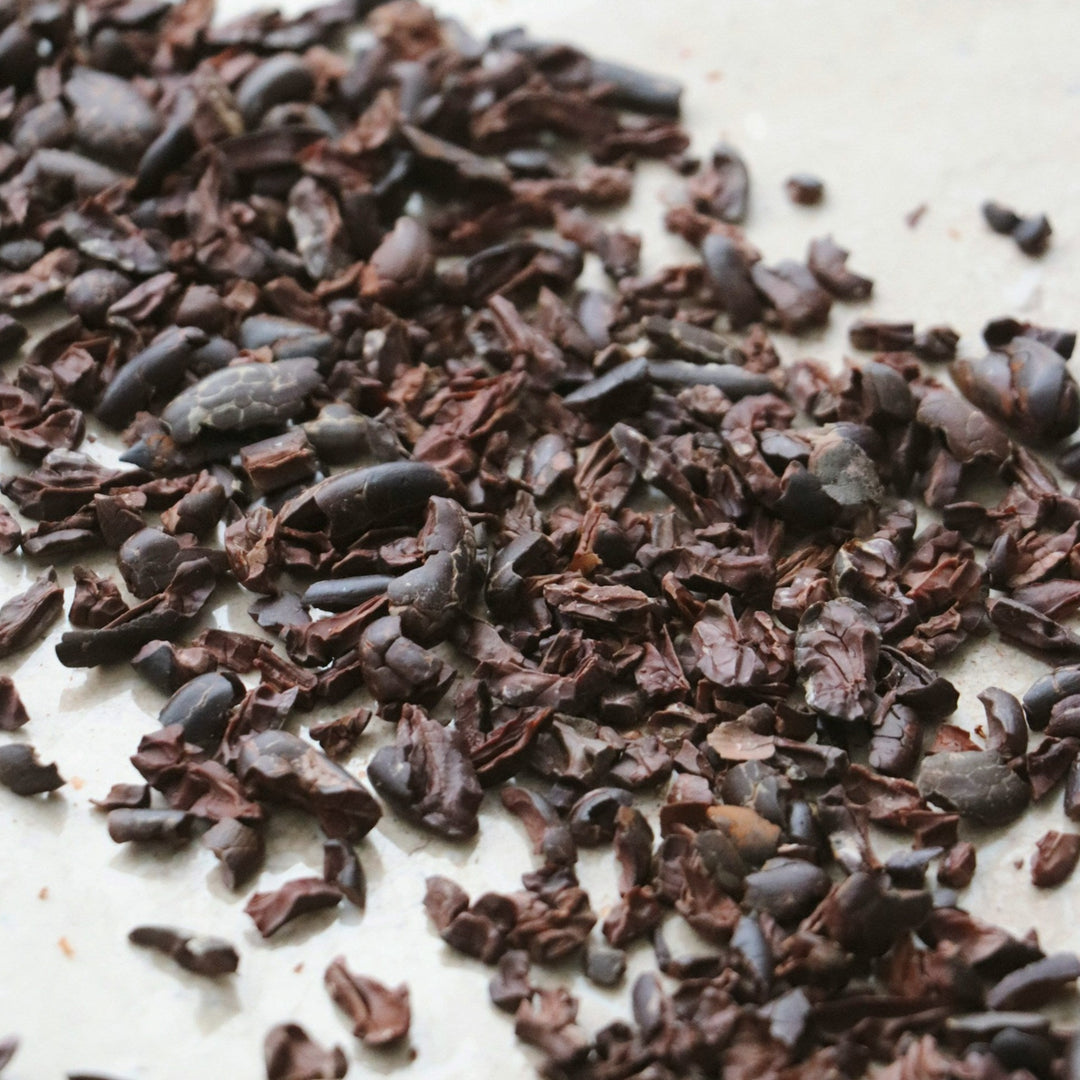 Raw organic cacao nibs in a clear bag, premium superfood for baking by AGT, rich in antioxidants.