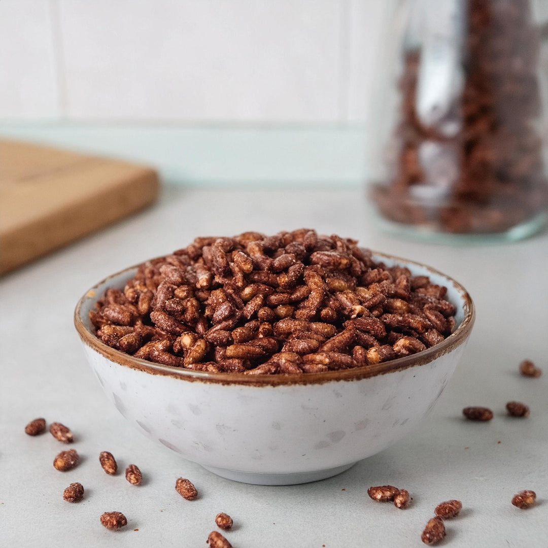 Premium chocolate puffed rice cereal in a bowl, showcasing sweet, crunchy texture, by Akalwayas.