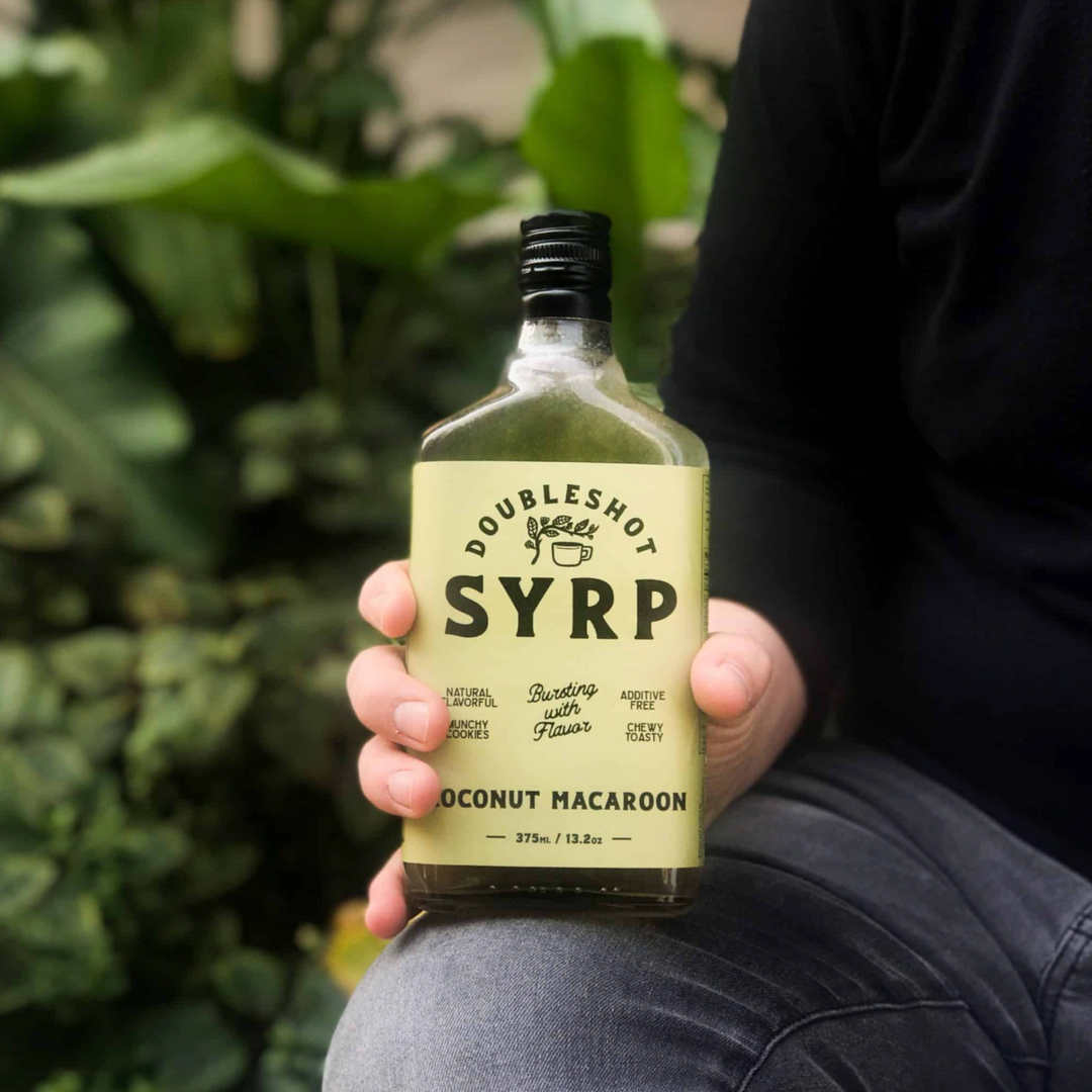Glass bottle of Double Shot Artisanal Coconut Macaroon Coffee Syrup with a toasted flavor label