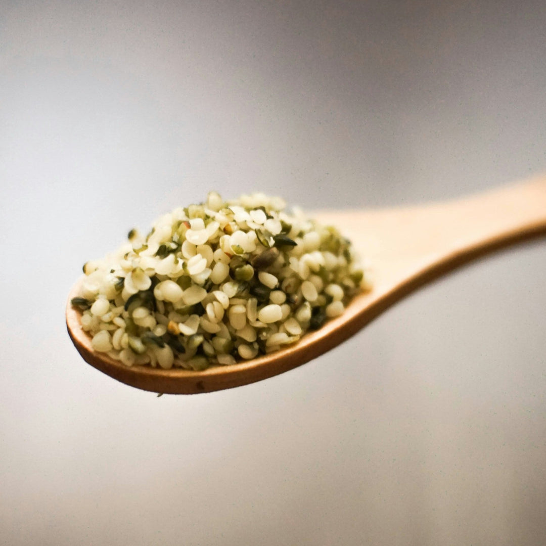 AGT Organic Raw Dehulled Hemp Seed Hearts in a clear bag, showcasing small green seeds, gluten-free and high in plant protei