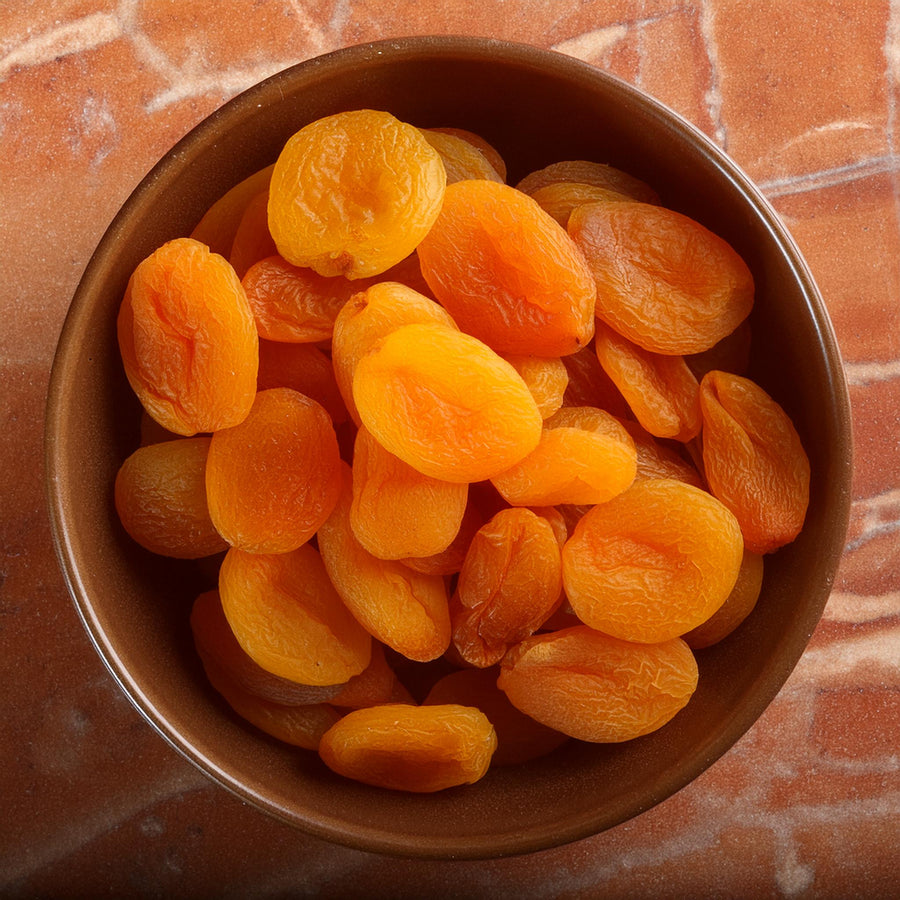 Amber-colored premium dried Turkish apricot halves in a bulk package by MultiSnack