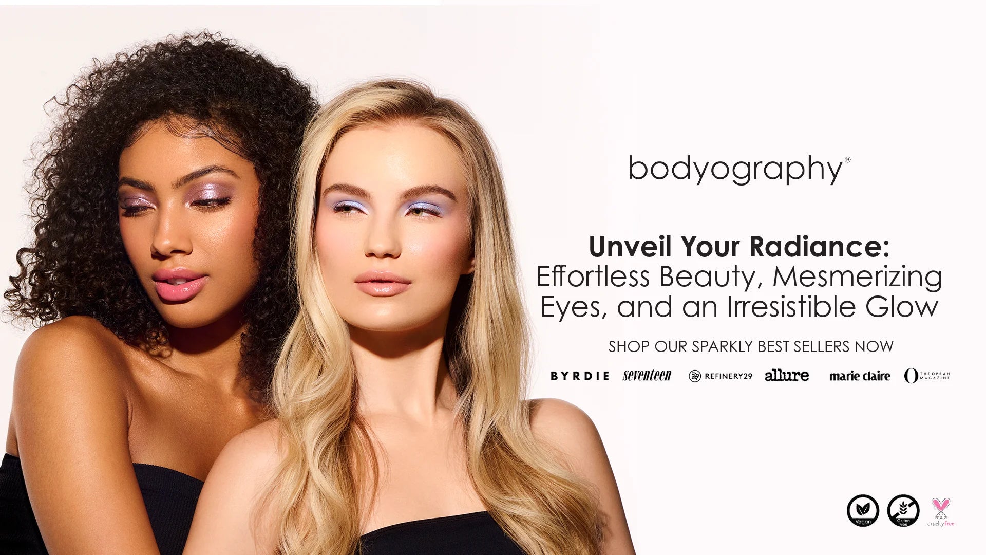 Two models showcasing Bodyography makeup with shimmering eyeshadow and radiant skin