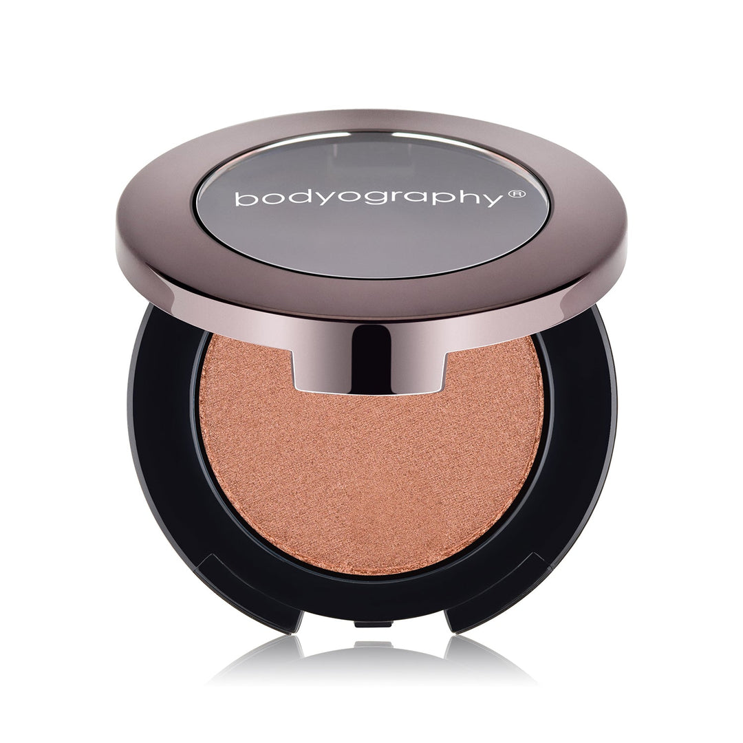 Pressed highlighter powder in Sunrise shade by Bodyography SA, featuring a smooth texture for a radiant complexion.