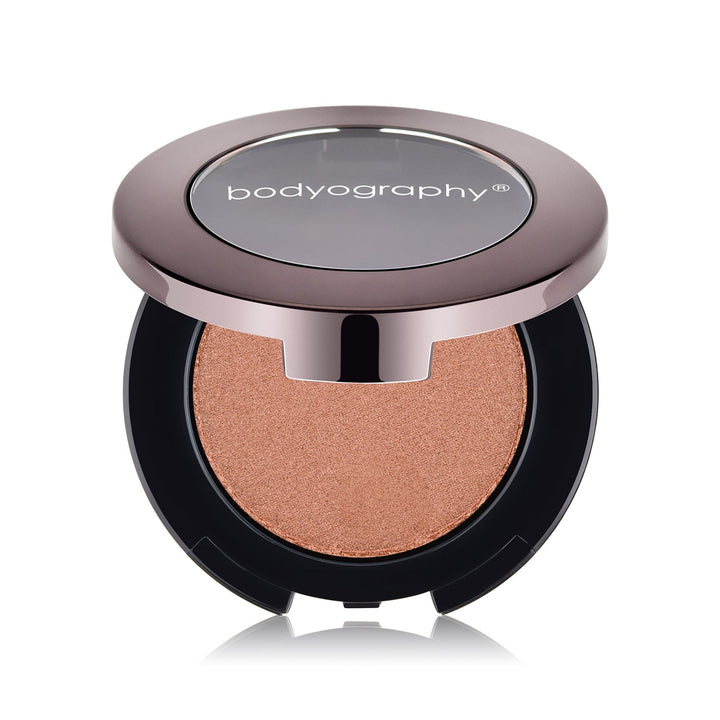 Pressed highlighter powder in Sunrise shade by Bodyography SA, featuring a smooth texture for a radiant complexion.