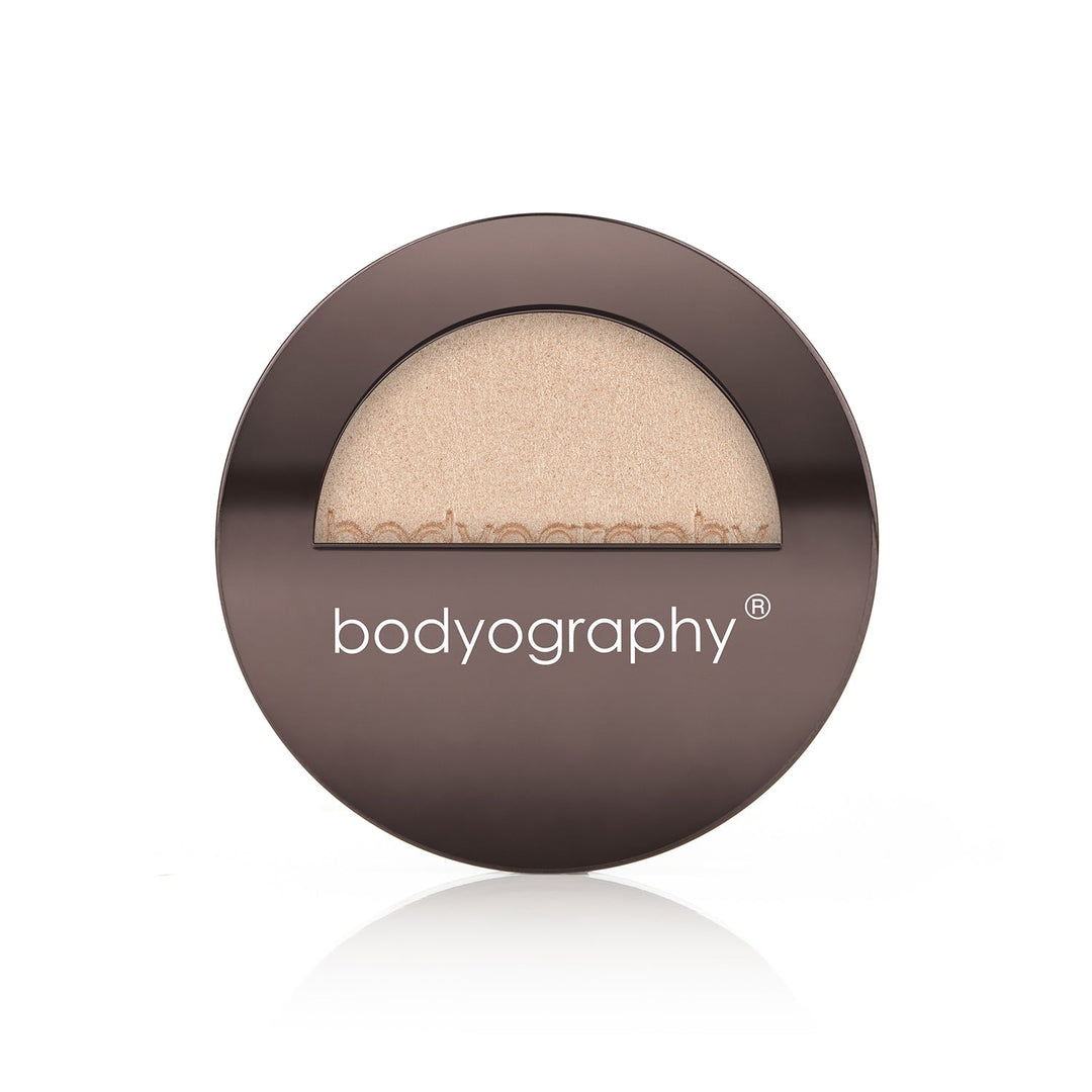 Pressed highlighter powder in Sunrise shade by Bodyography SA, featuring a smooth texture for a radiant complexion.