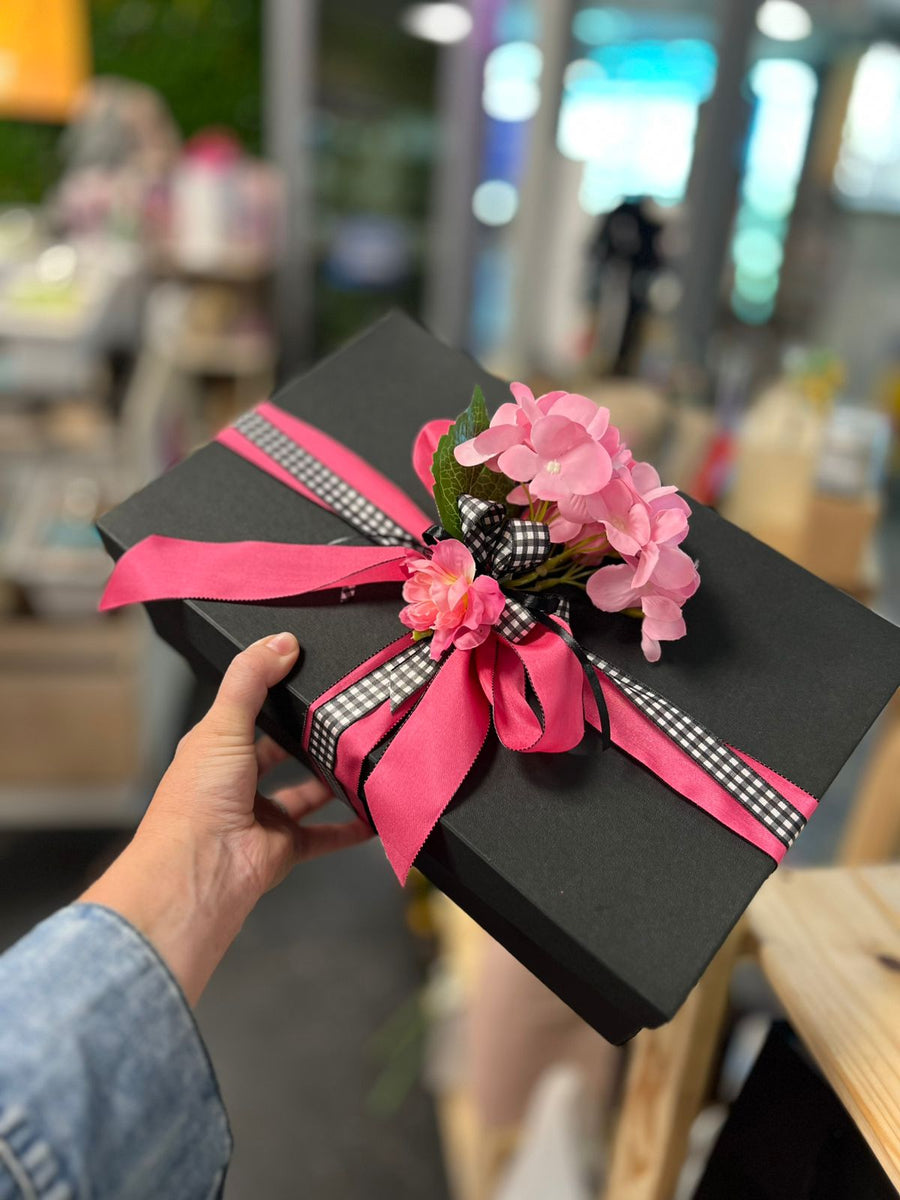 Chic black gift box with pink ribbon