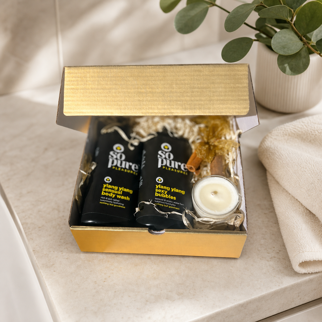 Open gold SoPure Pleasure pamper gift box on a calm bathroom vanity