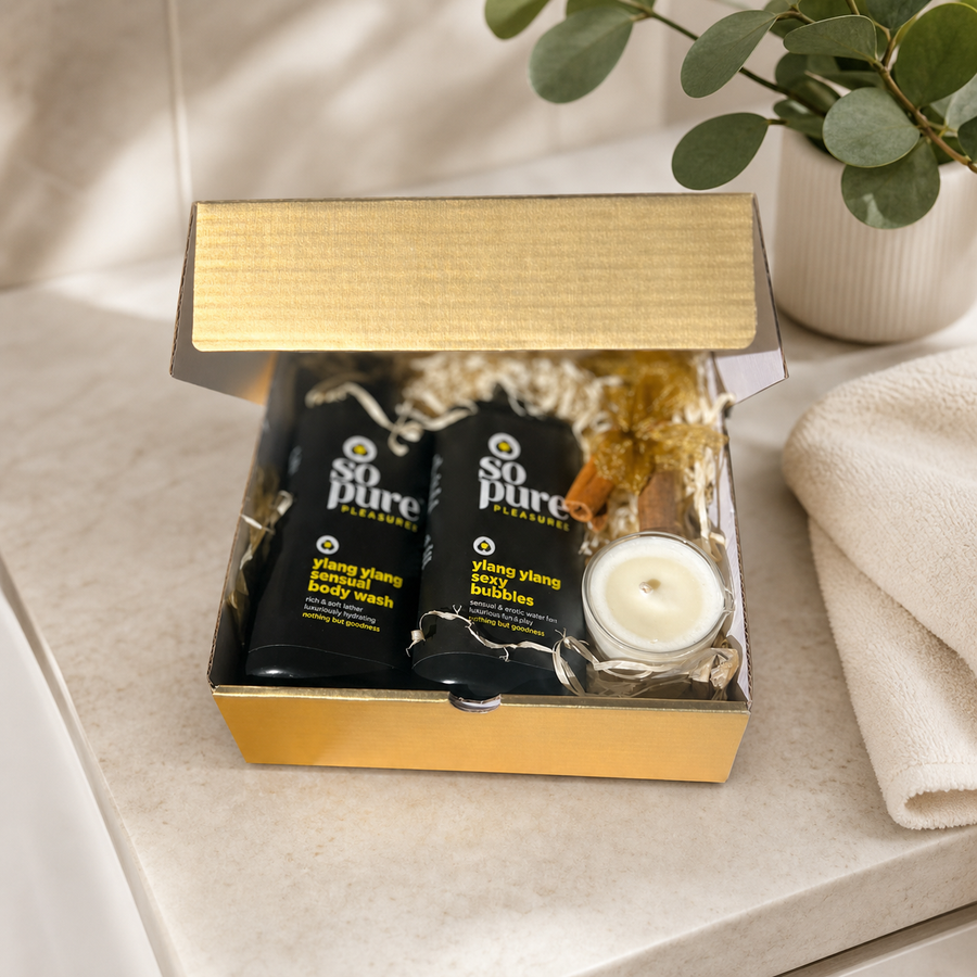 Open gold SoPure Pleasure pamper gift box on a calm bathroom vanity